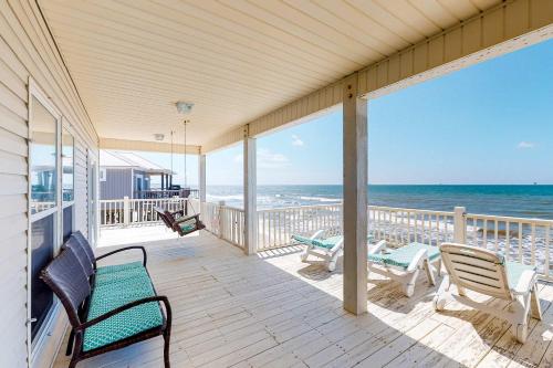 a porch with chairs and a view of the ocean at Sea the Gulf in Dauphin Island