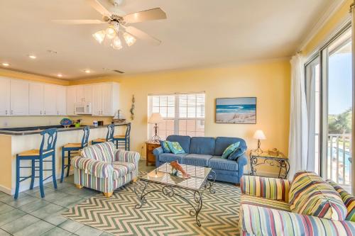 a living room with a couch and chairs and a kitchen at Gulf-front condo with lock-out feature shared pools & amazing views in Dauphin Island