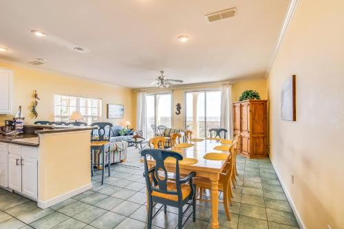 a kitchen and dining room with a table and chairs at Gulf-front condo with lock-out feature shared pools & amazing views in Dauphin Island
