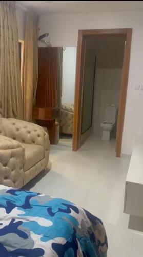 a living room with a couch and a bathroom at Yaba Elite Stays in Lagos