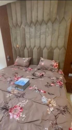 a bed with a blanket with a laptop on it at Yaba Elite Stays in Lagos