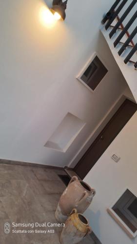 a vase sitting on the floor next to a staircase at tata Uccio in Matino