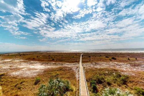 a long road in the middle of a field at Holiday Isle 413 in Dauphin Island