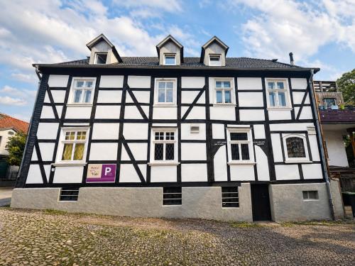 a black and white building on a street at Hotel Pemü in Arnsberg