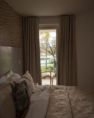 a bedroom with a bed and a window with a view at Caribbean Beachfront Resort in Puerto Plata