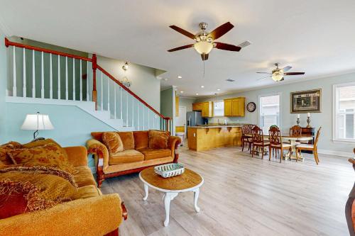 a living room with a couch and a table at Gulfview duplex with panoramic views large balcony and internet in Dauphin Island