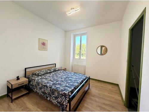 a bedroom with a bed and a window at Appartement Martell in Cognac