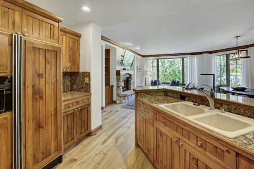 a kitchen with a large sink and wooden cabinets at Elkhorn Lodge, A Vail Resorts Property in Avon