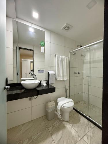 a bathroom with a sink and a toilet and a shower at Hotel Golden Park Salvador By Nacional Inn in Salvador