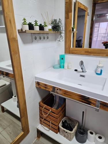 a bathroom with a sink and a mirror at Sky Apartment in Miramar