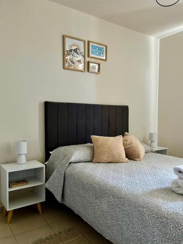 a bedroom with a bed with two pillows on it at Casa Akbar in La Cieneguita