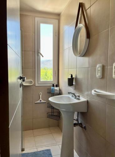 a bathroom with a sink and a shower and a mirror at Casa Akbar in La Cieneguita