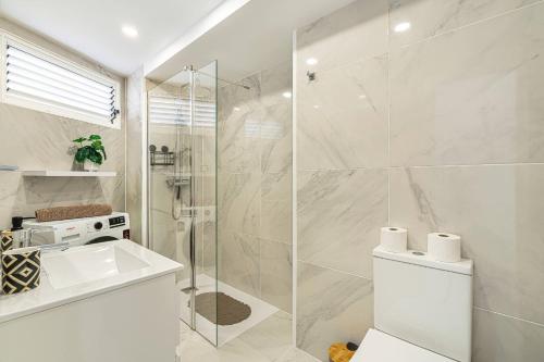a bathroom with a shower and a toilet and a sink at Magic View Costa Adeje in Costa de Adeje