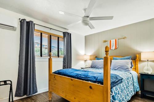 a bedroom with a wooden bed and a window at On the Waterfront in Fish Haven
