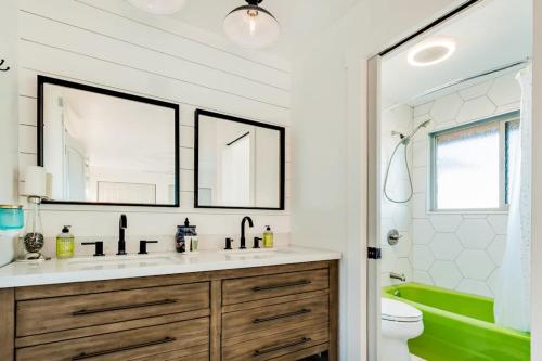 a bathroom with a sink and a green tub at On the Waterfront in Fish Haven