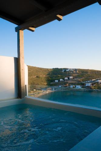 a swimming pool with a view of the water at Vista Mare Suites in Kithnos
