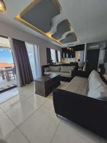 a living room with a couch and a table at Ionian Balcony in Athani