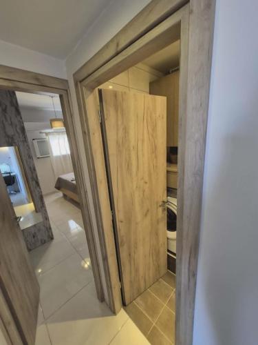 a sliding door in a room with a kitchen at Ionian Balcony in Athani