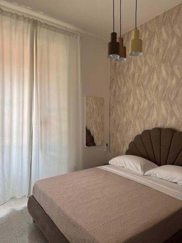 a bedroom with a large bed and a window at Mary 's Home in Caserta