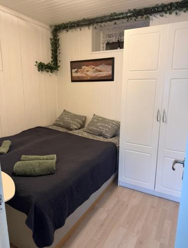 a bedroom with a bed and a large white door at Koselig leilighet in Flekkefjord