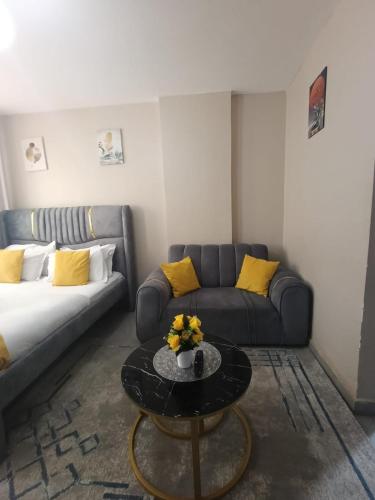 a living room with a couch and a coffee table at Pearls Haven in Kinoo
