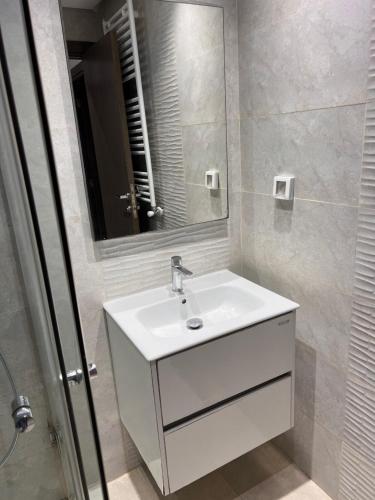 a bathroom with a white sink and a mirror at Modern Oasis near Airport & Lac 2 - Wahat Aouina in El Aouina Station