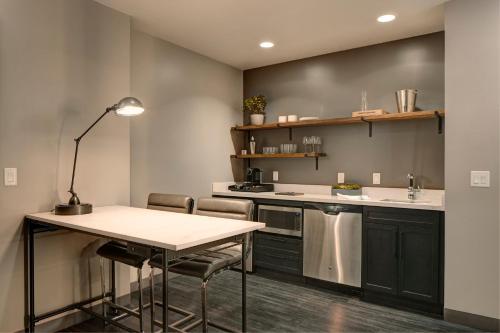 a kitchen with a table and some chairs at Archer Hotel Florham Park in Florham Park