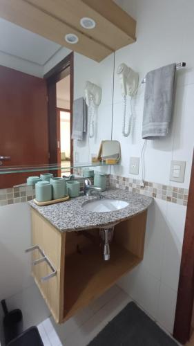 a bathroom with a sink and a mirror at Kariri Beach Waterfront Retreat in Caucaia