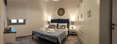 a bedroom with a bed with towels on it at Antel apartment in Naousa