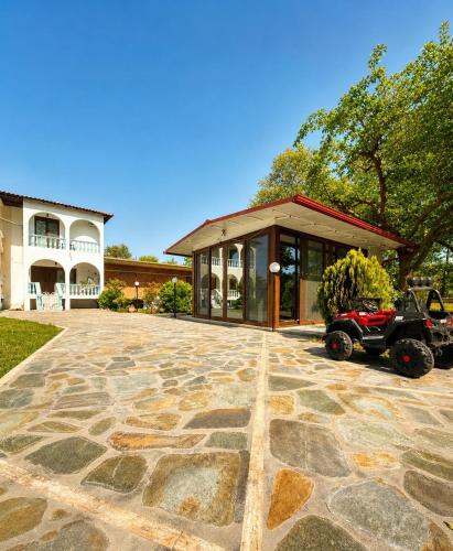 a home with a atv parked in front of a building at Villa Pilgrimos in Ierissos