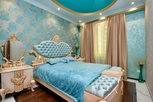 a bedroom with a blue bed and a mirror at Luxury Apartament in Amiryan Street Nerby Republic Square in Yerevan