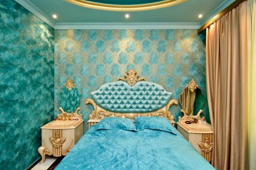 a bedroom with a blue bed and two night stands at Luxury Apartament in Amiryan Street Nerby Republic Square in Yerevan