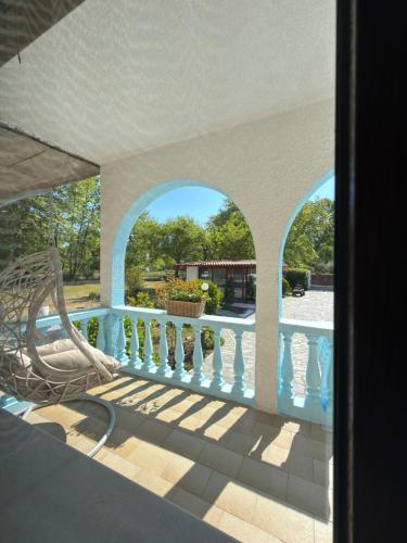 a view of a balcony with a chair on a porch at Villa Pilgrimos in Ierissos