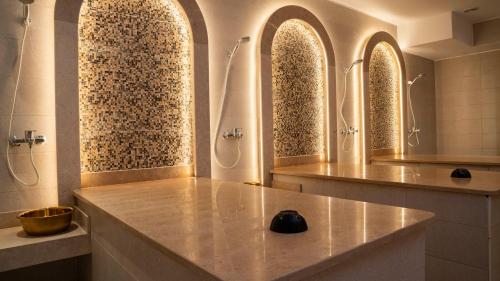 a bathroom with three sinks and a shower at TK Royal Hotel & SPA in Hurghada