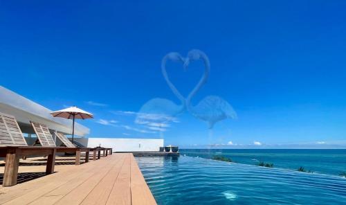 a swimming pool with a view of the ocean at Private Suite, Walk to the Beach, Oceanview Rooftop Pool, WiFi StarLink in Puerto Morelos
