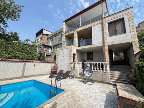 a house with a swimming pool in front of it at Villa in Norq -Marash in Yerevan