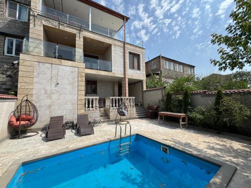a house with a swimming pool in front of it at Villa in Norq -Marash in Yerevan