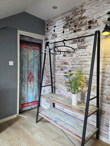 a room with a wooden wall with a swing and a door at Cocon industriel pour Nuits étoilées in Bourges