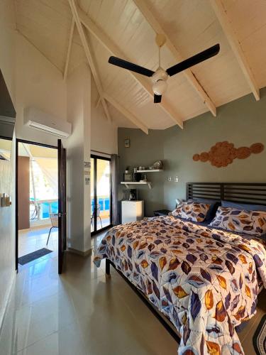 a bedroom with a bed and a ceiling fan at Casa MIA in Cabarete
