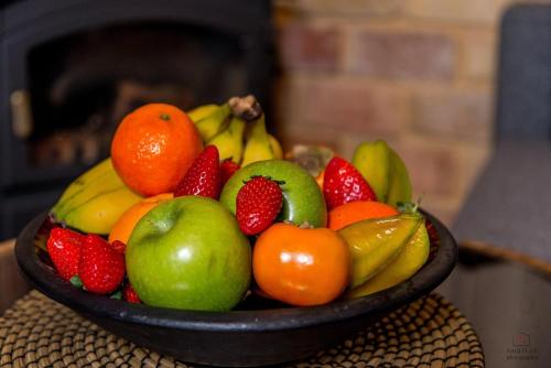 a bowl of fruit sitting on top of a table at At Gil's and Galit's Place- Hospitality, Health and Spa in Bruchim Qela' Alon