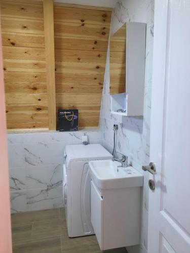 a white bathroom with a sink and a toilet at Mountain Houses Jakov in Žabljak