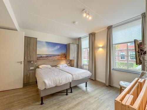 a bedroom with a bed and a painting on the wall at Dune Design 38 in Colijnsplaat