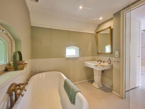 a bathroom with a tub and a sink at Twente Village in Haaksbergen