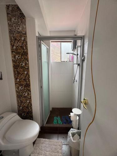 a small bathroom with a shower and a toilet at Valle Sagrado in Coya