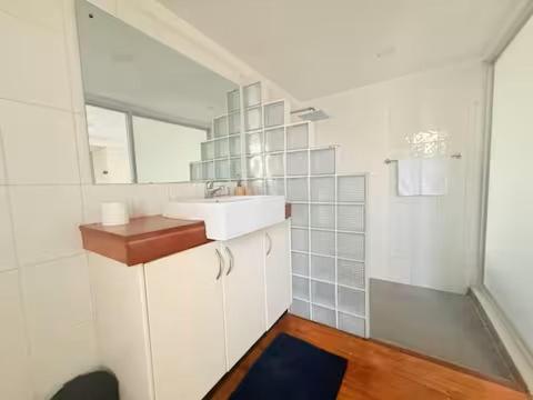 a white bathroom with a sink and a mirror at 2BR Oceanview Villas - Slice of Paradise, Central Suva in Suva