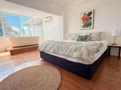 a bedroom with a large bed and a large window at 2BR Oceanview Villas - Slice of Paradise, Central Suva in Suva