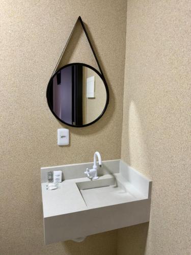 a bathroom sink with a mirror on the wall at Suite Home Sinop in Sinop
