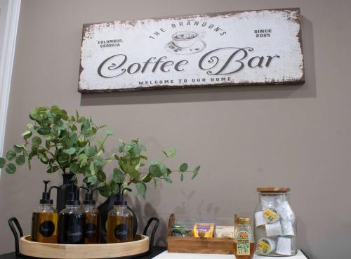 a coffee bar sign hanging on a wall at Peach State Hideaway The Columbus Escape in Columbus