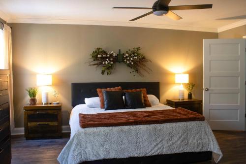 a bedroom with a large bed with two night stands at Peach State Hideaway The Columbus Escape in Columbus