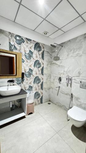 a bathroom with a sink and a toilet at Hotel Chhaya in Rishīkesh